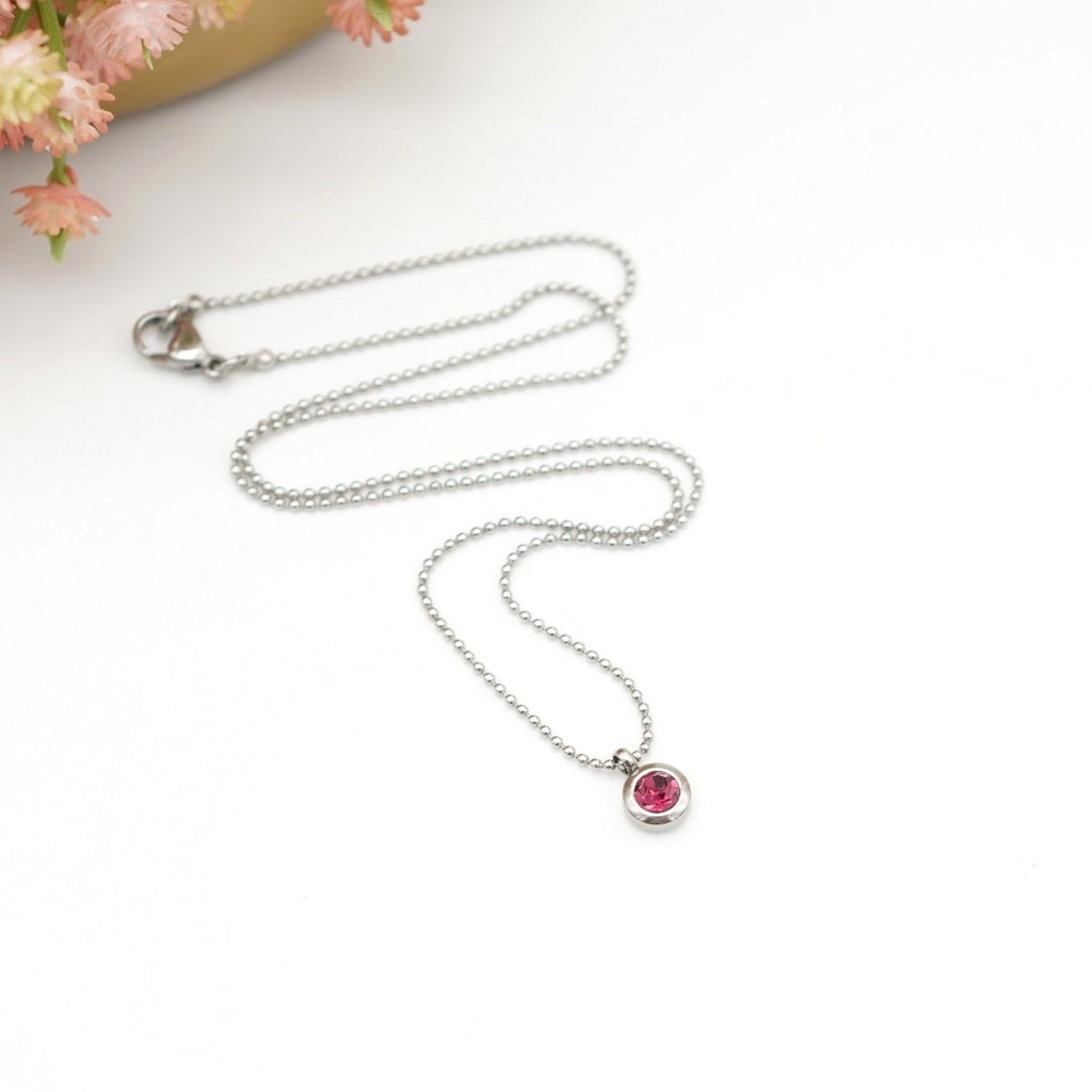 Edelstahl-Halskette mit rundem Anhänger &  fuchsiafarbenem Kristallstein